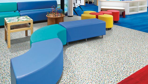 Interface Walk on By and Studio Set LVT in children's waiting area with colorful furniture