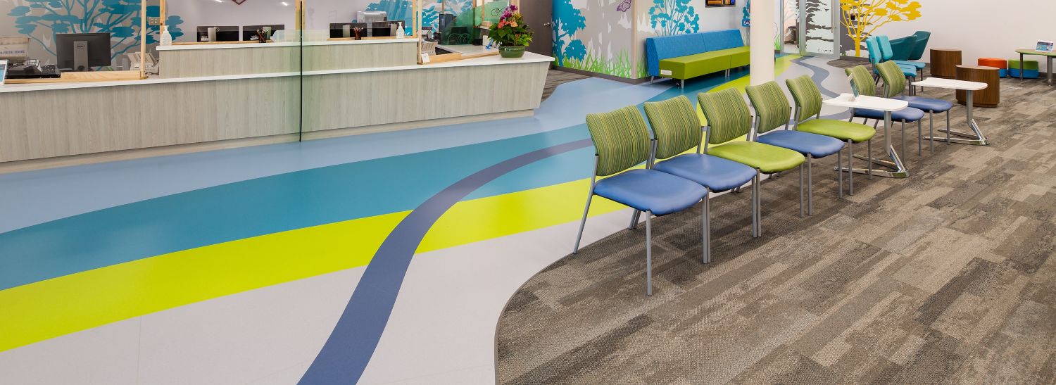 Interface Naturally Weathered plank carpet tile with noraplan sentica rubbr flooring in children's hospital lobby/waiting area