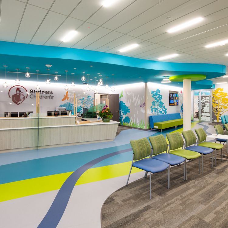 Interface Naturally Weathered plank carpet tile with noraplan sentica rubbr flooring in children's hospital lobby/waiting area