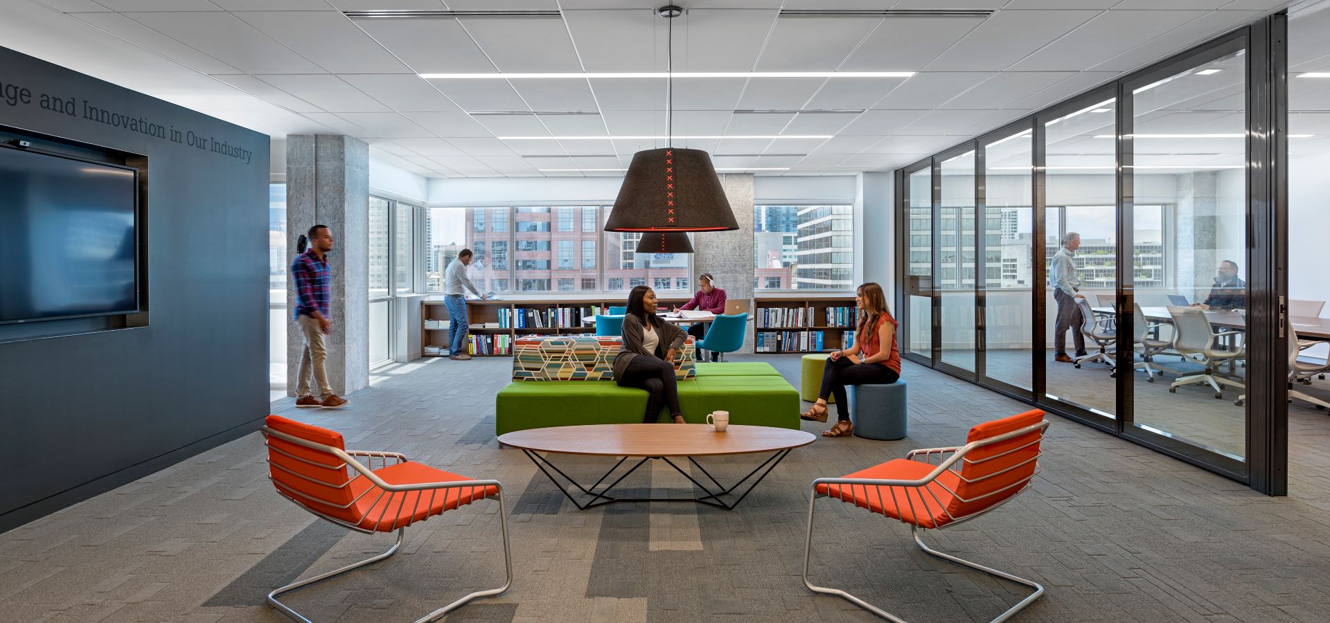 Interface EM551, EM552 and EM553 plank carpet tiles in open breakroom with people socializing