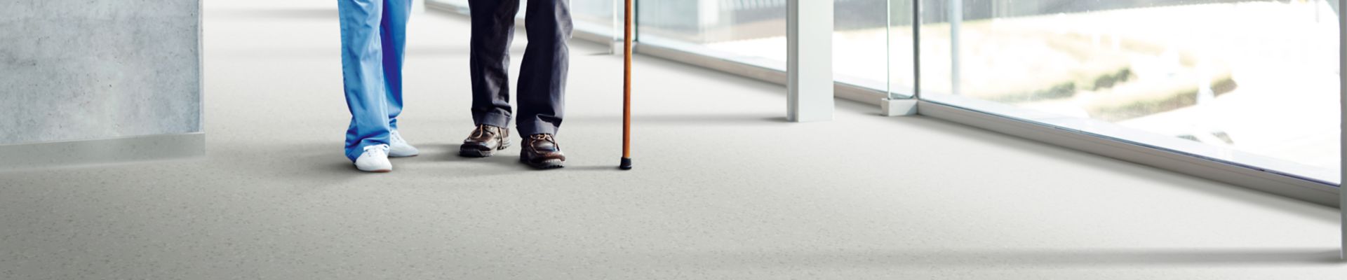 noracare seneo rubber flooring with elderly patient and nurse in corridor