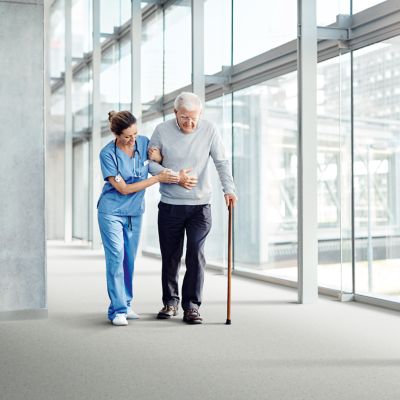 noracare seneo rubber flooring with elderly patient and nurse in corridor
