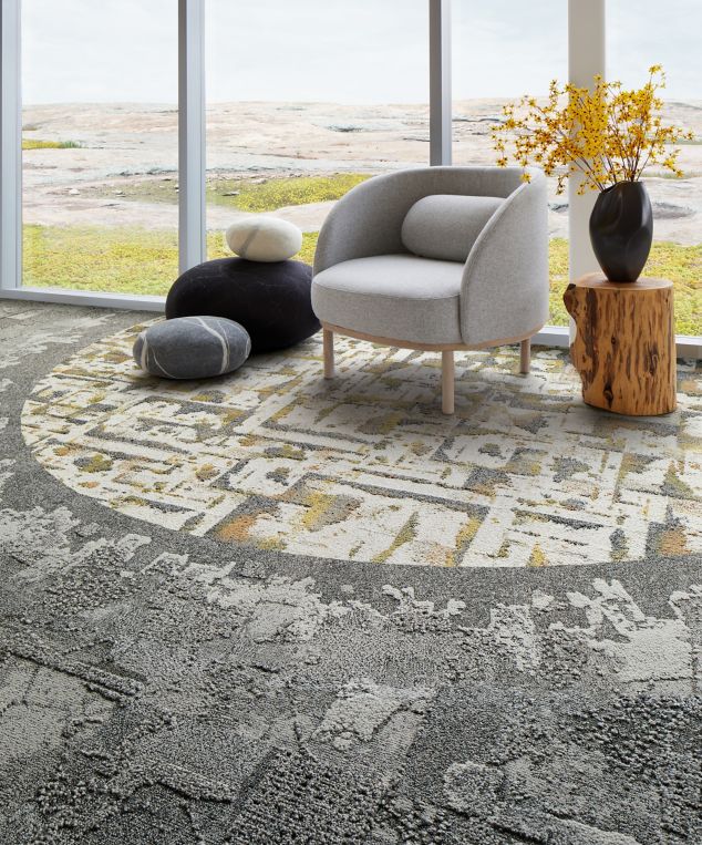 Interface Bridge Creek, Mountain Rock and Panola Mountain carpet tile in seating area with taupe chair and wood side table