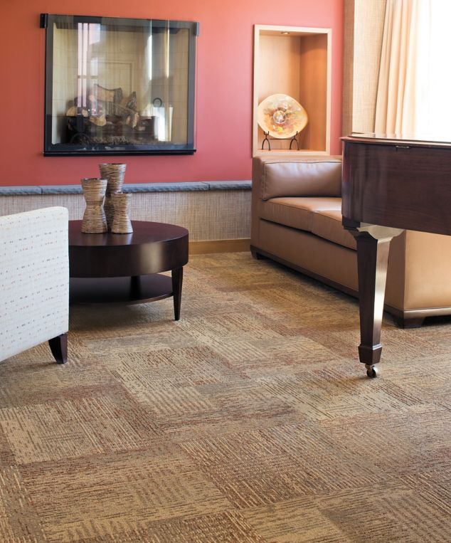 Interface Plain Weave carpet tile in lounge area with piano and seating