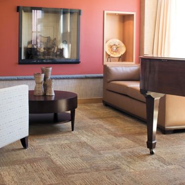 Interface Plain Weave carpet tile in lounge area with piano and seating