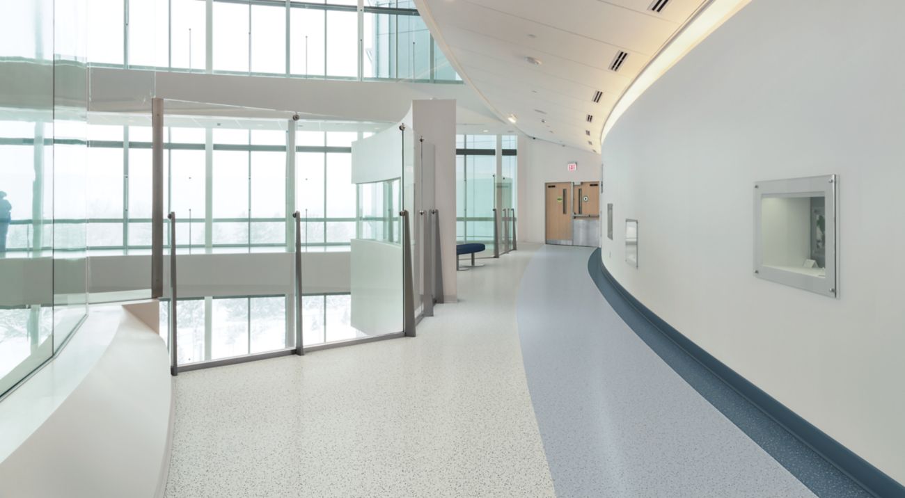 norament 926 pado rubber flooring in hospital corridor with glass walls