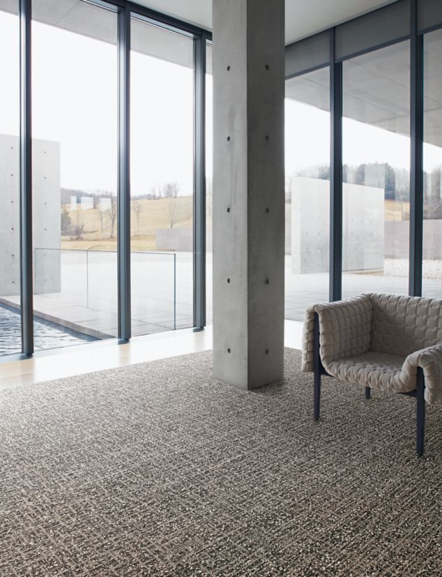 Interface WW890 plank carpet tile and Textured Stones LVT in lobby area with chair